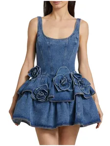 Detail of denim camisole mini dress with oversized 3D flower appliques and tiered skirt