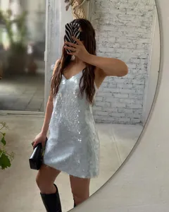 Detailed mirror selfie view of a shimmering light blue sequin V-neck party mini dress