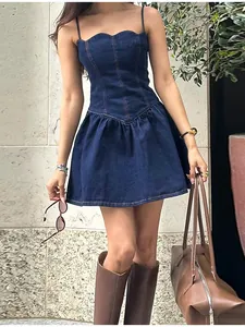 Close-up of slim-fit denim strap mini dress with corset-style bodice details