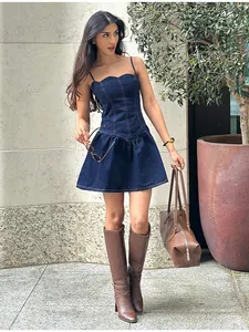 Detail shot of a sweet navy denim camisole dress featuring a flared hem and flattering fit