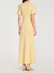 Back view of elegant yellow knit long dress with subtle sequin details and slim fit