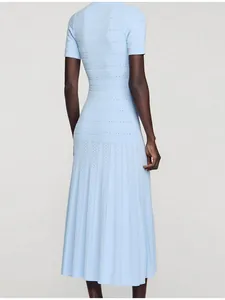 Back view detail of light blue knitted maxi dress with delicate pointelle patterns