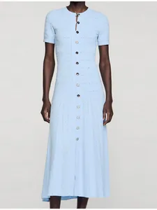 Detail view of a light blue short-sleeve knit midi dress with button-down front