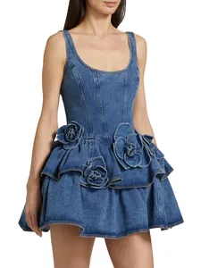 Chic blue denim mini dress featuring 3D floral appliqués and a tiered ruffle skirt.