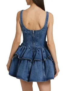 Back view of a blue denim tiered ruffle dress with a corset-style waist design.