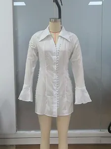 White slim fit textured mini dress with bell sleeves and button details on a mannequin