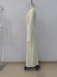 Side view of a pale yellow deep V-neck long dress with pleated waist on a mannequin