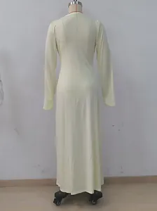 Back view of a light yellow long-sleeved dress with elegant drapes and slim fit.