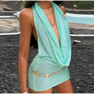 Close-up detail of a sparkling teal knit halter dress featuring a draped cowl neckline