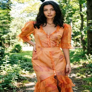 Close-up detail of the French V-neck printed dress with puff sleeves and ruffled hem.