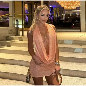 Elegance sexy peach shimmering knitted halter dress with a deep cowl neck on model