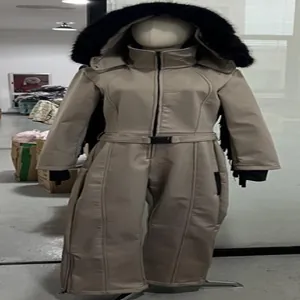 Full view of beige women's thermal ski jumpsuit with black faux fur hood on mannequin
