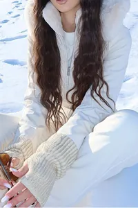 Detailed view of women's stylish white hooded ski jumpsuit with a faux fur trim