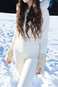 Elegant women's white hooded ski jumpsuit with faux fur collar and waist belt detail
