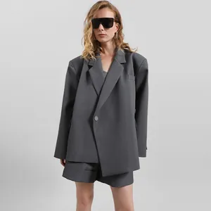 Conjunto de chaqueta y pantalones cortos grises asimétricos para mujer con estilo minimal