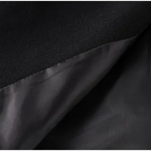 Macro view of black woolen coat fabric texture and smooth silky inner lining detail