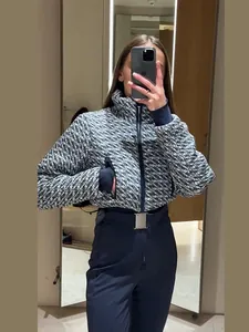 Detailed view of a stylish patterned winter ski jacket with high-waist pants and belt.