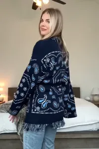 Detailed back view of a navy blue paisley print cardigan featuring trendy fringe trim