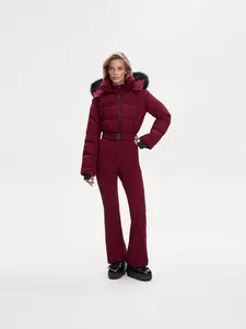 Maroon one-piece women's ski jumpsuit with fur hood and belted waist for winter sports