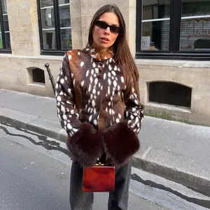 Street style view of women's deer print faux fur jacket with large brown fur cuffs