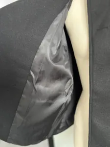 Close-up detail of the smooth inner lining and premium wool fabric of women's coat