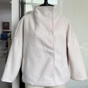Front view of an elegant off-white double-breasted short wool coat with a stand collar.