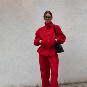 Full view of vintage red stand collar jacket with lantern sleeves and matching pants