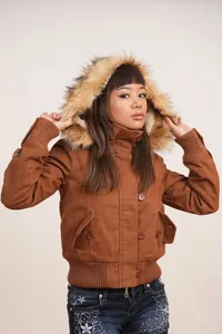 Close-up detail of vintage brown jacket featuring plush faux fur hood trim and buttons