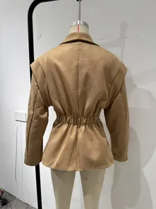 Detailed back view of a khaki British style waist-cinched blazer with large lapels.