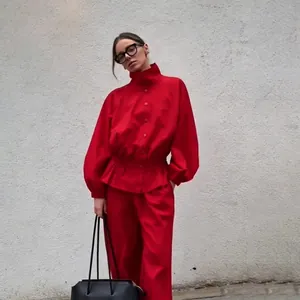 Detail view of a vintage red stand-up collar jacket with lantern sleeves and cinched waist