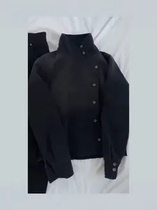 Vintage black stand-collar workwear jacket for women featuring an offset button closure