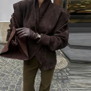Close-up of an elegant dark brown suede jacket with stylish large collar and waist fit.