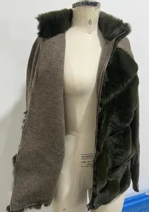 Detail of women's faux fur and knit patchwork jacket with fur collar and zip front.