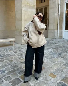 Female model wearing beige double-breasted short wool coat in outdoor street setting