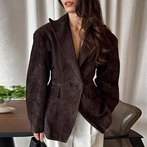 Detailed view of elegant chocolate suede blazer with wide lapel and waisted fit.