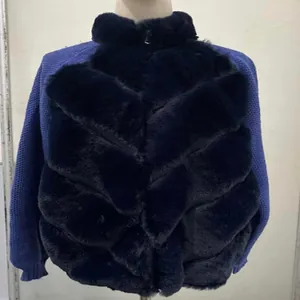 Close-up showing the black faux fur texture and blue knit sleeves of this winter jacket