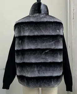 Back view of faux fur coat with grey and black stripes and knitted sleeves