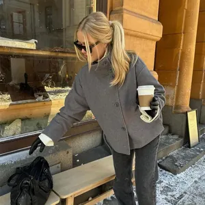 Fashionable grey wool coat with stand-up collar and button closure in street scene