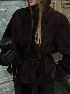 Elegant dark brown suede-textured jacket with waist-defining belt and oversized lapel