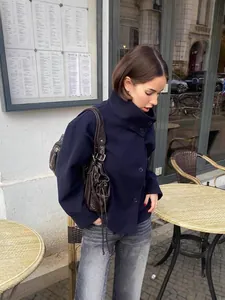 Elegant navy blue high-neck button-down woolen coat for women in a street style setting