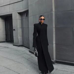 Elegant black long coat with padded shoulders and cinched waist detail for women