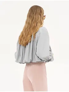 Detailed back view of a grey short windbreaker with elegant pleated ruffle design