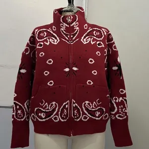 Detailed view of vintage burgundy paisley knit cardigan with front zipper closure