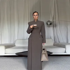 Elegant dark grey long coat with structured padded shoulders and cinched waist silhouette