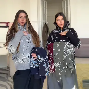 Detailed shot of models wearing casual paisley print knit zip-up cardigans in various colors