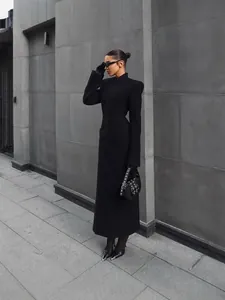 Elegant long black coat with padded shoulders and cinched waist for women
