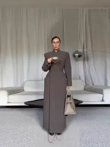 Elegant long brown coat featuring structured padded shoulders and cinched waist design for women