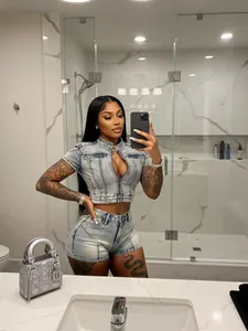 Sexy washed denim two-piece set with cropped zip-up top and high-waist shorts.