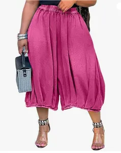 Detail view of stylish magenta loose wide-leg denim trousers for women