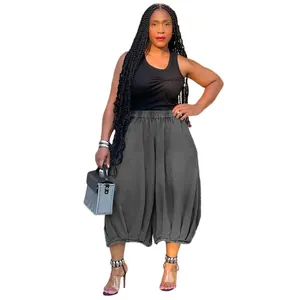 Close-up detail of women's loose grey harem pants featuring elasticized cuffs and high waist